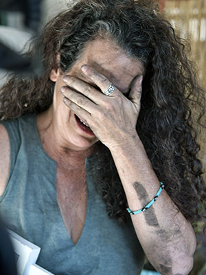 Hamas War: Hadas Calderon cries in her home three weeks after the October 7 massacre. Her mother was brutally murdered; and her two children, Sahar and Erez, and their father, Ofer, were kidnapped by Hamas terrorists.